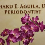 Interior Photo: Practice sign for Richard E. Aguila, DDS, Periodontist behind purple orchids