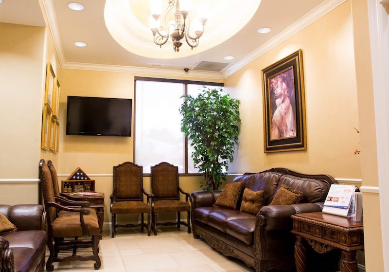 Waiting room with comfortable chairs and sofa in Dr. Aguila's practice